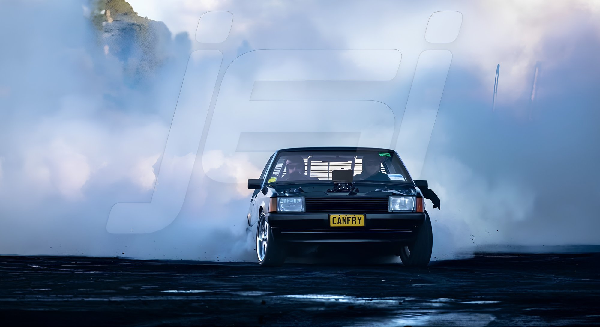 A Holden Commodore doing a burnout on the skid pad, buried in tyre smoke.